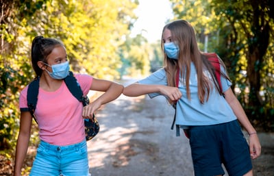 emozi-students-bumb-elbow-wearing-masks